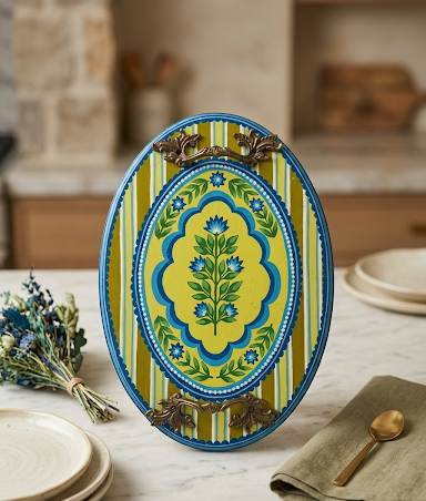 An oval platter painted in yellow and cobalt with a central botanical bouquet, brass acanthus handles.