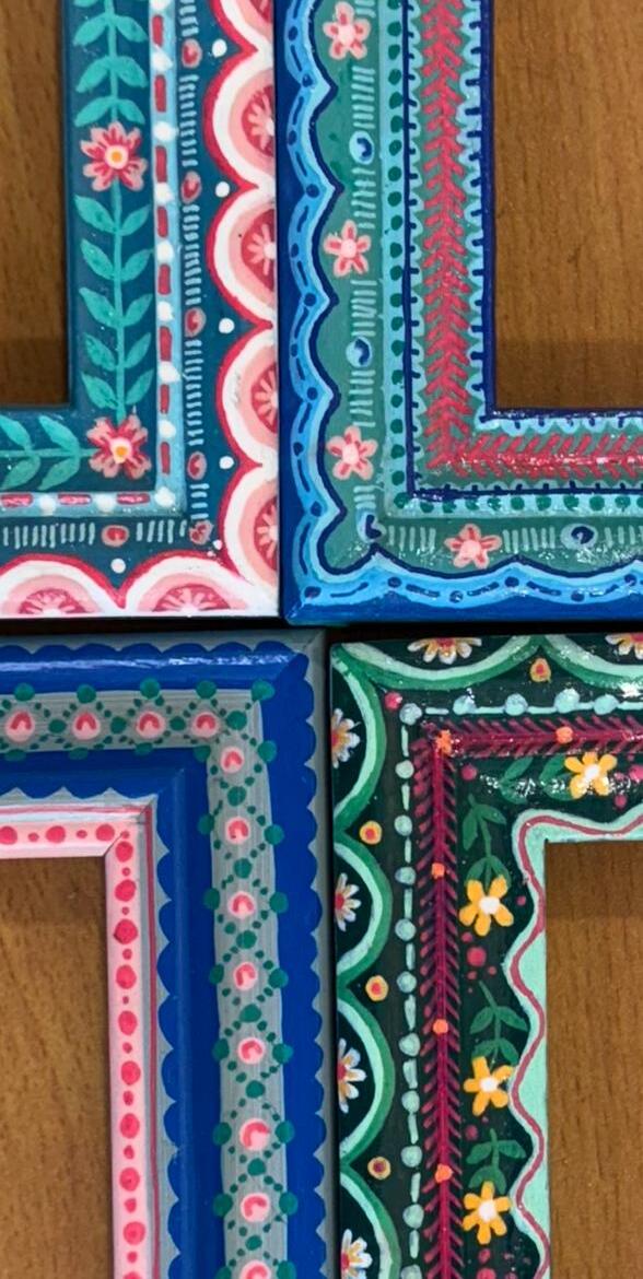 Four hand-painted picture frames, close-up of their decorative corners.
